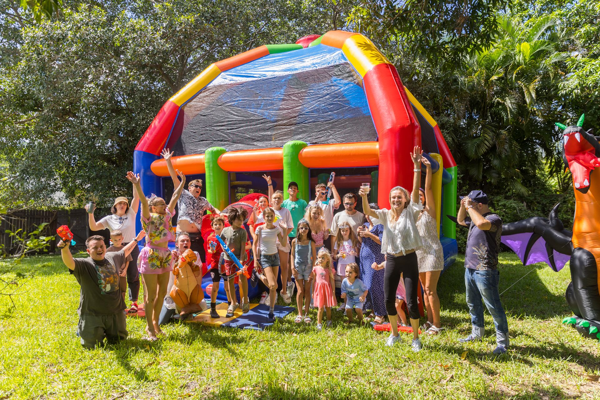 Children and parents cheer in front of a giant inflatable dragon at the end of the Dragon Quest